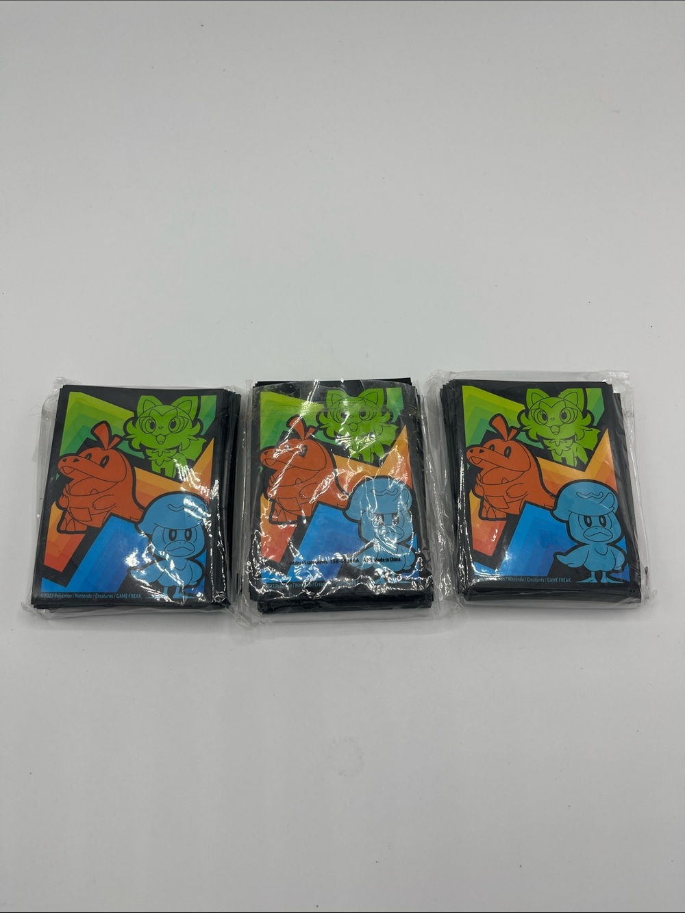 Pokémon TCG card sleeves featuring Sprigatito, Fuecoco, and Quaxly 195
